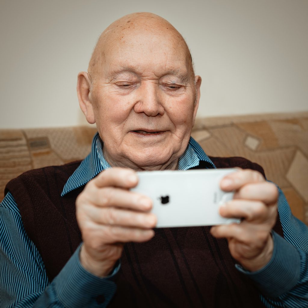 An older man holding a smartphone