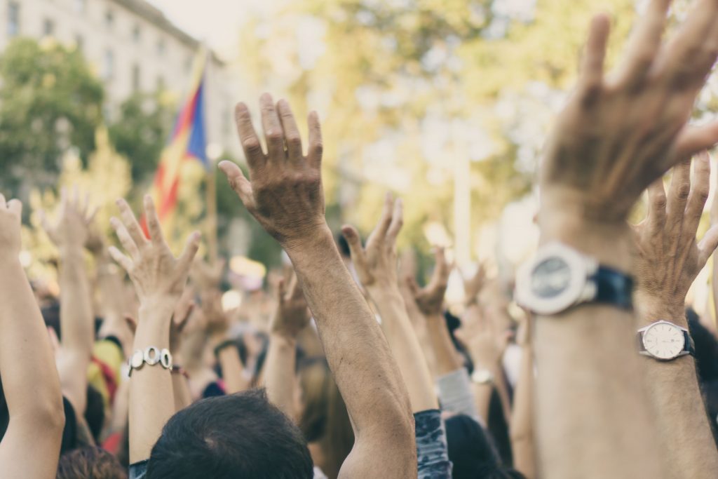 A group of people with their hands raised in the air